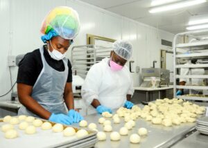 Nia (Left) and Derion prepare the dough for bread rolls