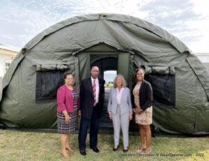 U.S. Ambassador to Barbados and the Eastern Caribbean Linda Taglialatela and Deputy Executive Director of the RSS Graham Archer (center) view one of the donated tents.