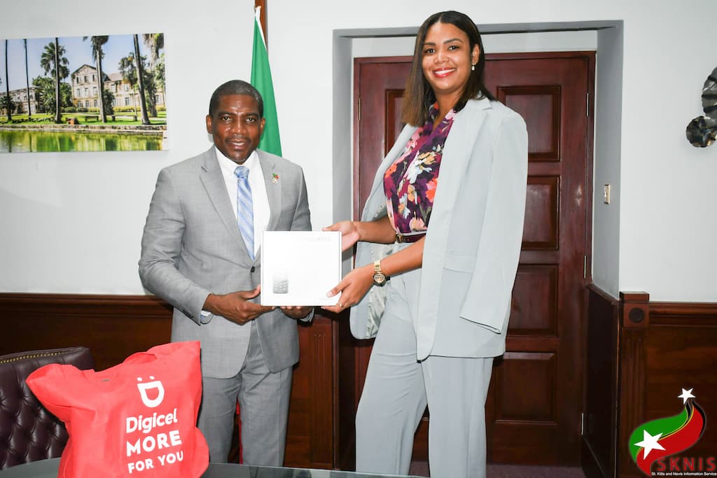 Prime Minister of Saint Kitts and Nevis, Hon. Dr. Terrance Drew receiving donation of satellite phones from CEO of DIGICEL St. Kitts and Nevis, Karlene Telesford.