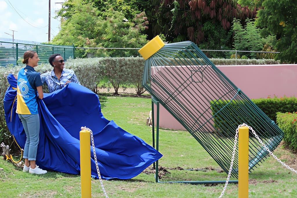 President of the Barbados Olympic Association (BOA), Sandra Osborne, and professional surfer and BOA Athlete Sustainability Ambassador, Chelsea Tuach, unveil the BOA’s new recycling initiative — a bottle-shaped recycling bin.
