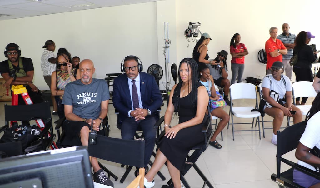 Premier of Nevis, the Honourable Mark Brantley, Minister of Tourism in the Nevis Island Administration (c) with producers Chuck (l) and Bree West (r) on the set of OCTET Production’s movie at the Malcolm Guishard Recreation Park, Nevis