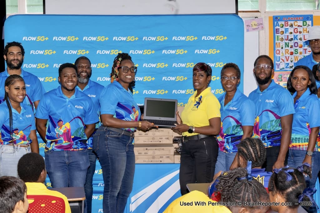 Senior Manager Communications at Flow, Toni Yarde, presenting the 10 laptops and laptop sleeves to principal of Erdiston Special School Donna Holder.