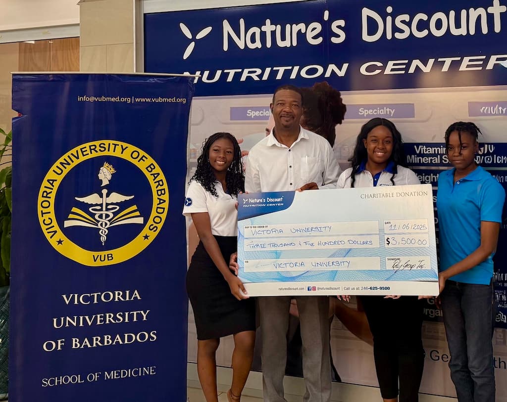 Left to right: Chinara Blunte, Store Assistant; Dennis Holder, Deputy Dean; Ashley Serieux, Branding Coordinator; and Tanea Alleyne, Store Assistant, during the official cheque handover and goodwill gesture marking the partnership between Nature’s Discount and Victoria University to support the re-launch of the Sky Mall Free Clinic.