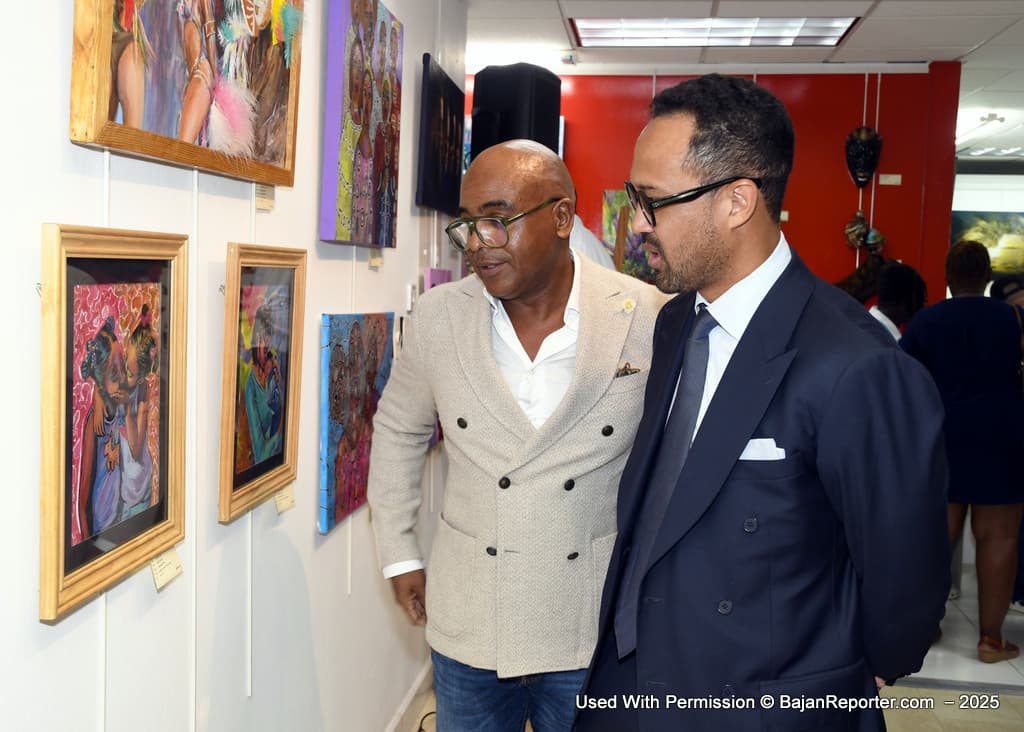 Giles Carmichael (right) who deputized for his father Sir Trevor, examines the winning painting from an Established Artist “Hearts Love” by Jamila Greaves with Paul Michael Jenkins, (left) International Investment Advisor at CIBC Caribbean