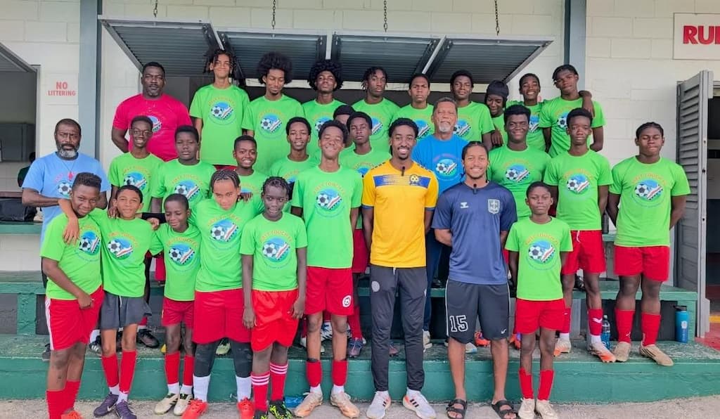 (front) National Tridents Khalil Vanderpool-Nurse (third from right) and Nathan Sealy (second from right) recently spoke to young footballers at First Touch F.C. about their career journeys to date.